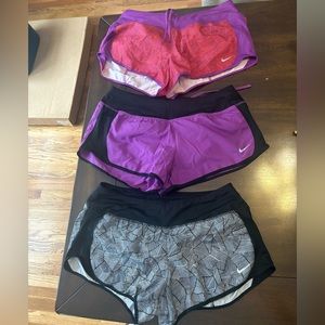Three Nike dri-fit running shorts